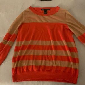 Orange and cream sheer sweater has a small snag with hanging string on it